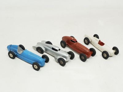 several toy cars are lined up in a row on a white surface