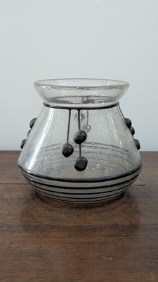 a glass vase that is sitting on a wooden table