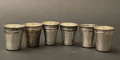 six silver cups are lined up in a row on a table