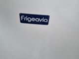 a white refrigerator with a blue sticker on the side of it