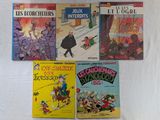plusieurs livres pour enfants sont alignés sur une surface blanche
