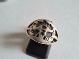 silver ring with a horse and rider on it sitting on a black stand