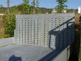 a metal bed sitting in the middle of a yard