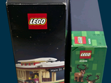 two boxes of legos sitting next to each other on a table