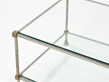 a glass coffee table with a metal frame on top of it