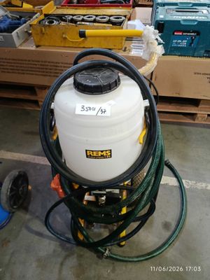 a large white tank with a hose attached to it in a warehouse