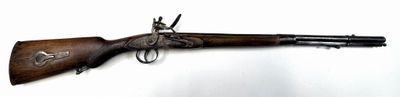 an old gun with a wooden barrel and a metal handle