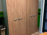 an image of a room with a desk and two cupboards