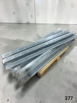 four pieces of gal steel nails are stacked on a wooden stand