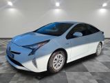 a white toyota prius parked on a checkered tile floor