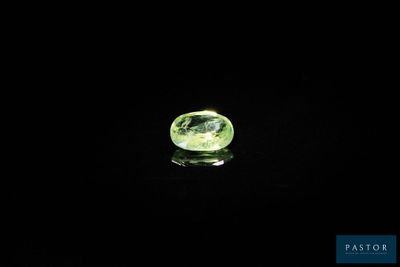 a close up of a green gemstone on a black background
