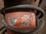 a close up of a rusted fire hydrant with a sticker on it