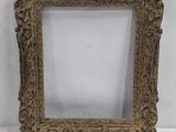 a gold ornate frame with a white background