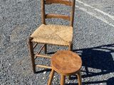 a wooden chair and a wooden stool in a parking lot