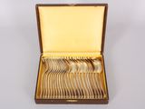 a wooden box with silverware in it on a white surface
