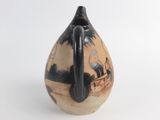 a black and white vase with a picture of a boat on it