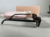 a pair of glasses sitting on a table next to a pink box
