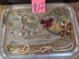 a tray with many different types of jewelry on it