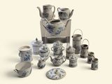 many pieces of blue and white pottery on the table