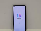 a close up of a phone on a table with a logo on the screen