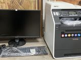 a computer and a printer sitting on a desk next to each other