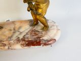 a statue of a man holding a bird on a marble base