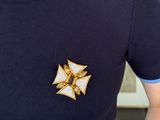 a close up of a person ' s shirt with a brooch on it