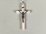 a cross with a crucif on it hanging on a wall