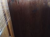 a wooden cabinet in the corner of a room