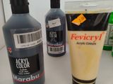 a bottle of liquid and a tube of liquid next to each other