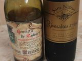 two bottles of wine sitting next to each other on a table