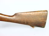 an old wooden rifle on a white surface with a white background