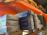 many stacks of boxes on a shelf in a warehouse
