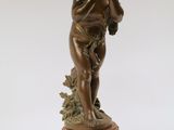 bronze statue of a cupid holding a flower on a marble base