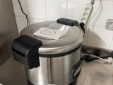 stainless steel counter top with an electric pressurer on top of it
