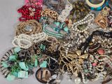 a pile of assorted jewelry sitting on a table