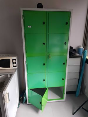 a green cabinet in the corner of a room