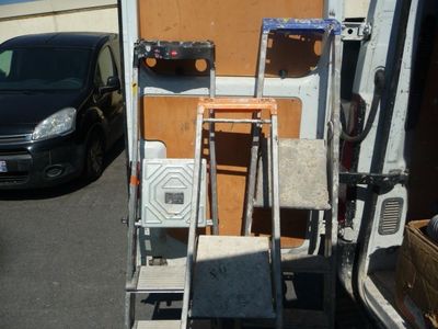 an image of a van with a ladder and a chair in the back