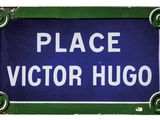 blue and white sign with the words place victor hugo on it