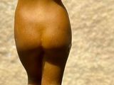 a figurine of a nude woman holding a basketball ball