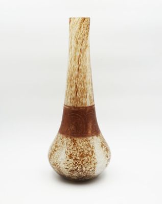 a brown and white vase sitting on a white surface
