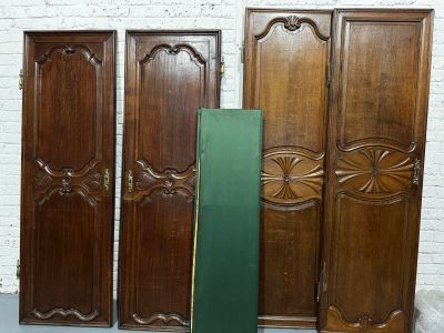 three wooden doors that are next to each other