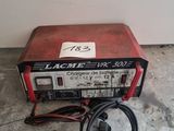 an image of a red and black machine sitting on top of a cement floor