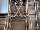 a metal ladder with a seat on it in a building