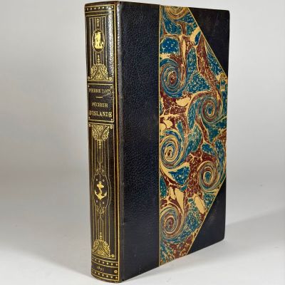 an old book sitting on top of a white table next to a white wall