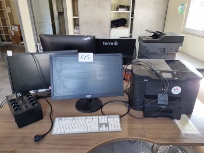 a desk with a computer, printer, and other electronics on it