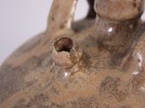 a close up of a vase with a hole in it