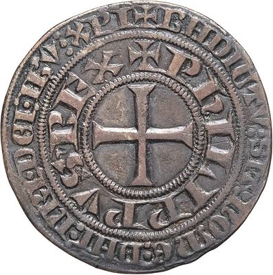 a close up of a coin with a cross on it