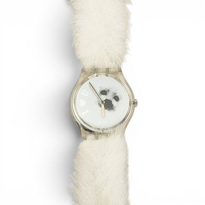 a white watch with a dog face on it ' s face