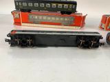 three toy trains sitting next to each other on a table